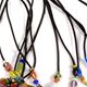 10 pc assortment of rubber chokers with cats-eye beads and a magnetic clasp.