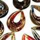 50 piece pack of glass open teardrop pendants in assorted colors. Appx 2" long