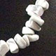18" choker of approximately 10mm chunky style Howlite chips with lobster claw clasp and 1.5" adjustable chain. 