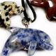 10 pc bag of assorted 25mm gemstone dolphins on cord.