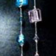 12 piece bag of assorted glass beads and silver thread necklaces. Each bag has 12 different colors of glass beads. 34" long