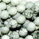 16" strand of faceted 8mm round white howlite beads.