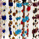 12 piece bag of assorted glass beads and gold thread chokers. Each bag has 12 different colors of glass beads. 1" chain with lobster clasp