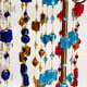 12 piece bag of assorted glass beads and silver thread chokers.  Each bag has 12 different colors of glass bead chokers. 1' chain with lobster clasp